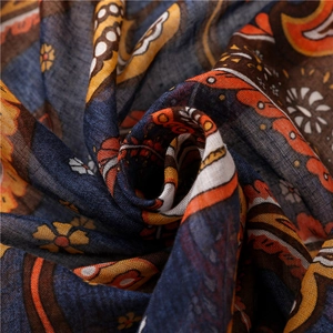 Detail of bohemian paisley printed scarf showing woven texture and deep navy cotton fabric