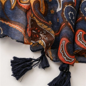 Detail of dark blue Paisley scarf featuring classic fringe and vintage floral patterns