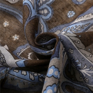 Detailed macro view showing the paisley pattern and soft cotton linen texture of this scarf