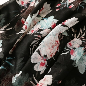 Close-up of soft cotton-linen scarf fabric with bohemian large floral prints in black