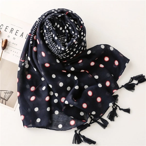 Navy blue bali yarn scarf with white polka dots, red circles and decorative fringe