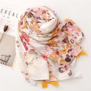 Detail of floral ink painting pattern and handmade tassels on cotton linen scarf