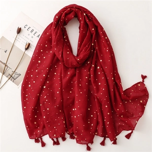 Detail of dark red lightweight scarf with gold foil stars, moons and tassel fringe
