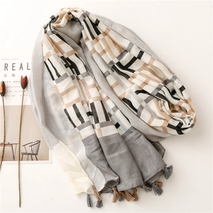 Detail of geometric pattern scarf with soft linen feel and decorative tassels