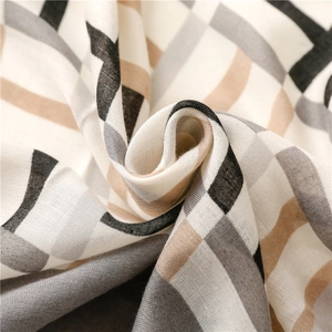 Detailed view of soft beige and grey geometric plaid cotton linen fabric with drape texture