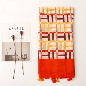 Detail of geometric pattern scarf with cotton linen feel and decorative fringe tassels