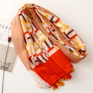 Bohemian geometric pattern scarf with colorful tassels, spread on a white background