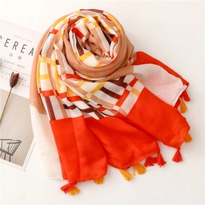 Detail of multi-color plaid scarf with fringes and lightweight breathable texture