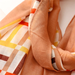 Close-up of fine texture on orange geometric cotton-linen scarf with satin finish