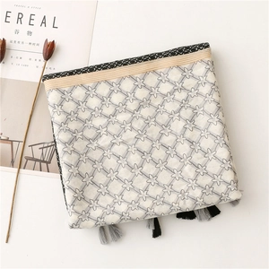 Detail of star pattern cotton linen scarf with elegant fringe tassels and border