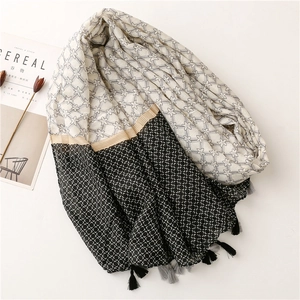 Detail of cotton linen blend shawl featuring geometric star patterns and tassel edges
