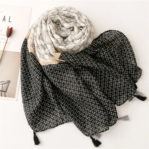 Elegant geometric star print scarf with dual-tone black and white panels and fringe