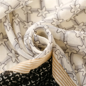 Lightweight cotton-linen feel shawl with geometric stars and floral patterns in neutral tones