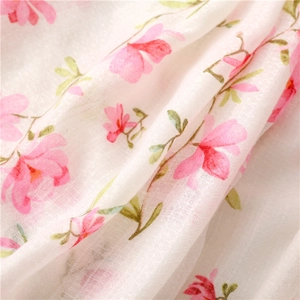 Macro detail of breathable cotton linen fabric with floral pink flower and leaf print