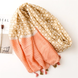 Close-up of geometric star pattern scarf with decorative tassels and textured fabric