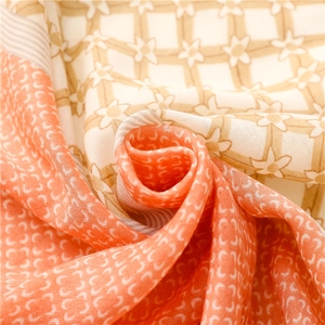 Detailed close-up of soft floral and star pattern scarf with elegant draping folds