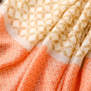 Macro detail of geometric star patterns and floral prints on lightweight cotton linen scarf
