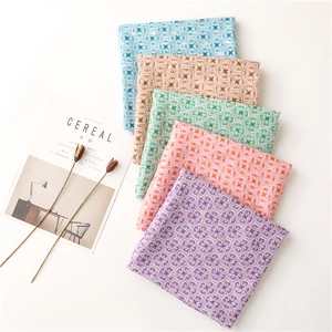 Detailed close-up of geometric gold foil patterns on multi-colored cotton linen scarves