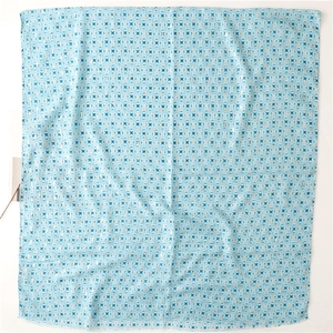 Detail of light blue geometric floral scarf with soft cotton-linen feel and frayed edges