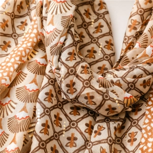 Détail de tissu d'écharpe au toucher lin avec éventails et motifs floraux dorés