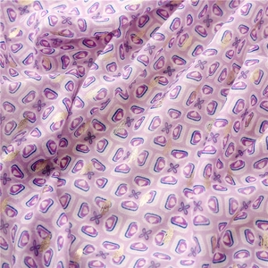 Detail of light purple cotton linen scarf with geometric print and gold foil texture