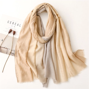Detail of gradient cotton linen scarf featuring silver sequins and fringe edges