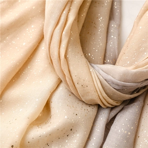 Detail showing champagne and grey gradient scarf with golden metallic foil specks