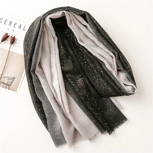 Detail of gradient grey cotton-linen shawl with fine gold glitter and soft fringe