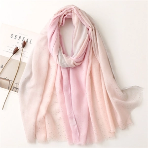Pink and grey gradient linen-feel shawl with shimmering gold foil dots on white surface