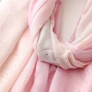 Macro detail of pink gradient scarf showing soft texture and gold foil glitter accents