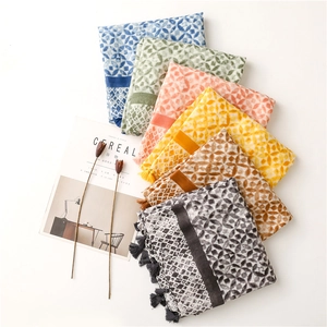 Detailed view of colorful kaleidoscope pattern scarves with matching elegant tassels