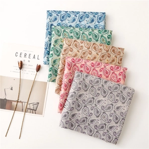 Detailed texture of ethnic paisley scarves in five colors with silver foil stamping