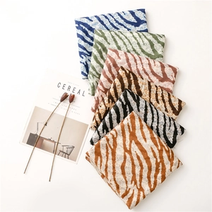 Macro detail of six leopard and zebra print cotton scarves in various colors