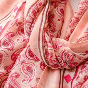 Close-up of pink paisley scarf with gold silver foil stamping and soft bohemian texture