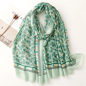 Mint green paisley printed cotton linen scarf with silver accents and frayed edges