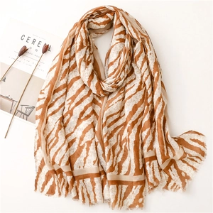 Close-up of tiger print scarf texture with raw edges and soft cotton linen feel