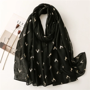 Lightweight black scarf with gold deer pattern displayed as a stylish wrap shawl