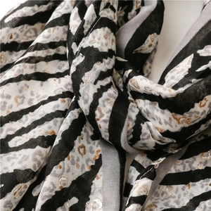 Detail of leopard and zebra print scarf with metallic silver shimmer and soft texture