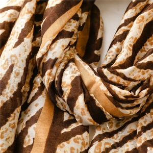 Detailed view of leopard and zebra animal prints on lightweight chiffon fabric shawl
