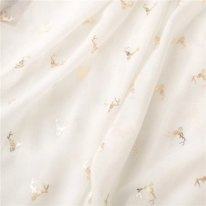 Detailed close-up of white sheer scarf with elegant gold foil reindeer head patterns