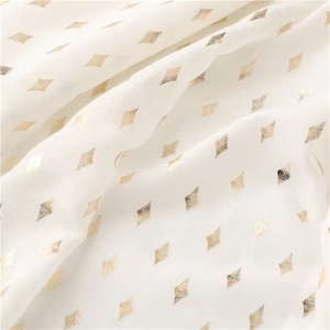 Detailed macro view of white voile scarf featuring gold foil geometric diamond patterns