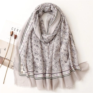 Detail view of purple paisley scarf with cotton-linen texture and fringe edges