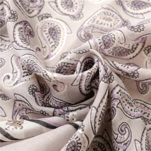 Macro view of paisley print linen-feel scarf with metallic silver stamped accents