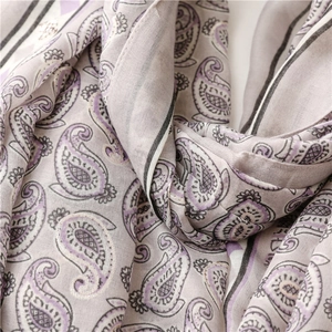 Close-up of soft paisley print scarf in lavender and grey with elegant draped texture