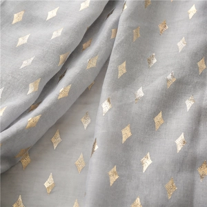 Detail of light grey cotton-linen scarf featuring metallic gold rhombus foil pattern