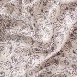 Detail of silver foil paisley pattern on vintage cotton linen style pashmina shawl
