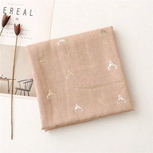 Close-up of pink linen-feel scarf featuring golden deer antler foil print pattern