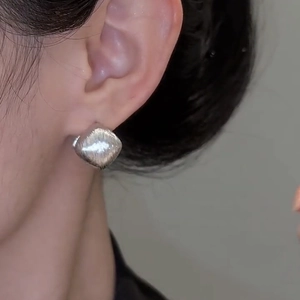 Elegant silver square brushed metal earrings shown worn for a minimalist French style