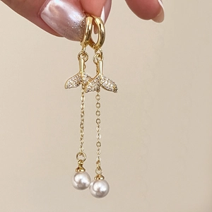 Elegant gold fishtail tassel earrings with shimmering crystals and white pearls