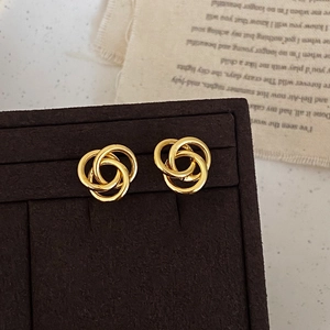 Elegant gold twisted interlocking hoop earrings with a polished finish for women